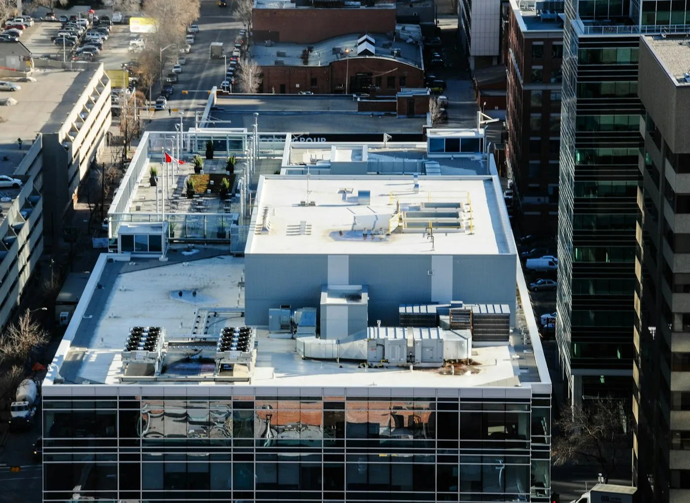 Aerial view of rooftop mechanical plant across city buildings