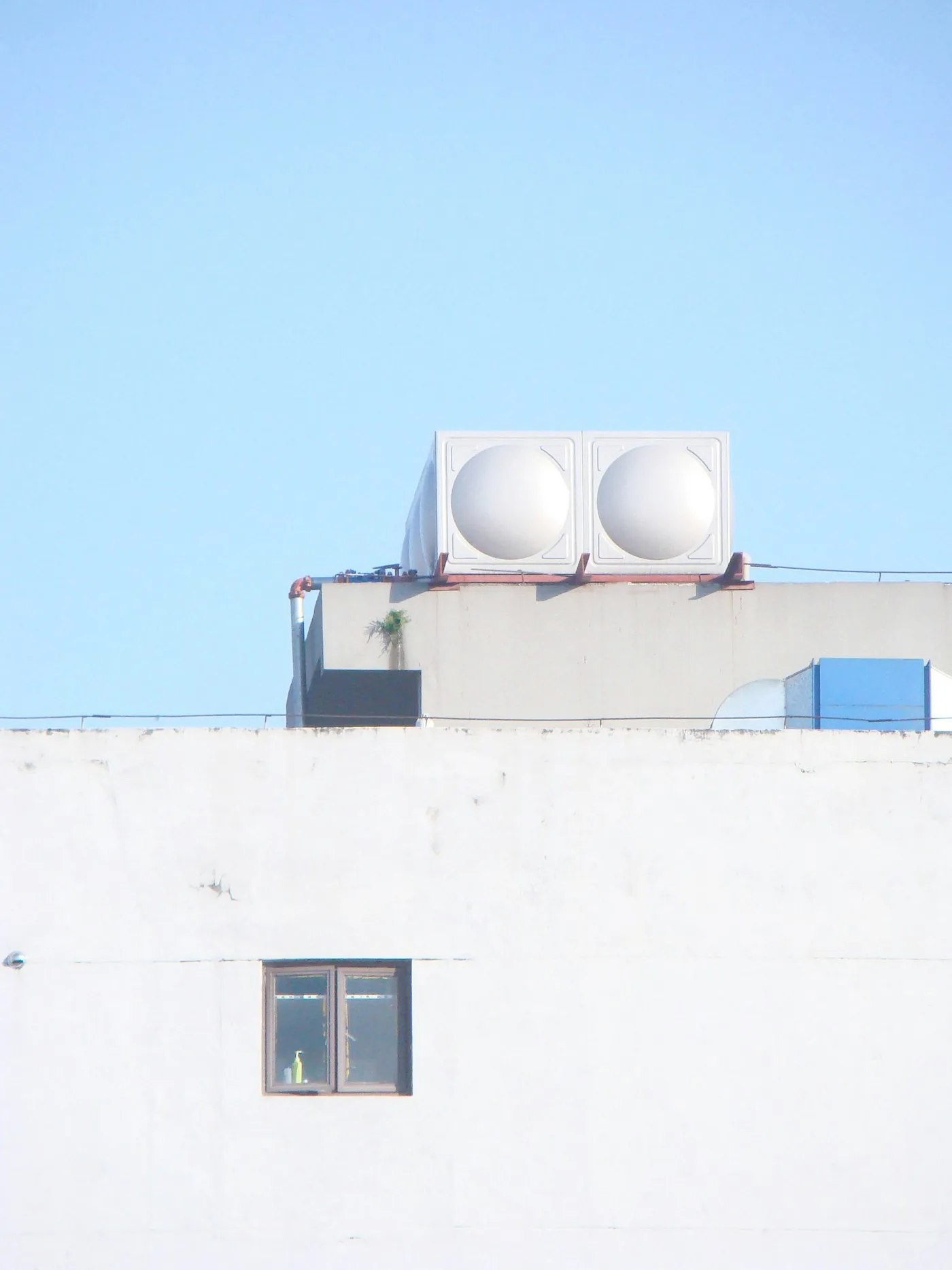 Rooftop mechanical plant on a white commercial building