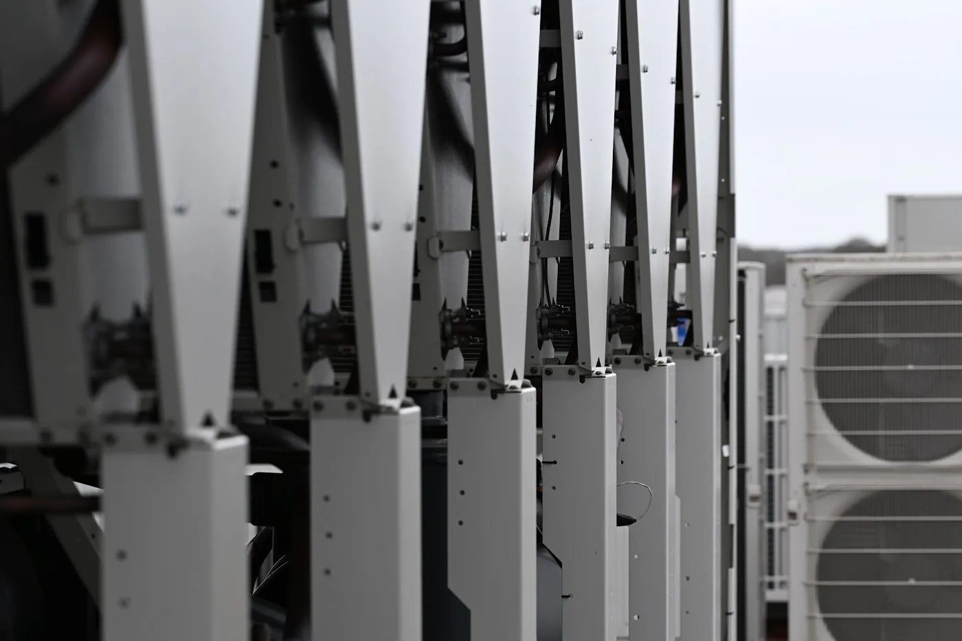 Row of rooftop air conditioning condenser units on a commercial HVAC system