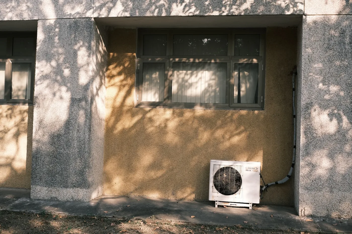 Air conditioner mounted on the side of a building exterior