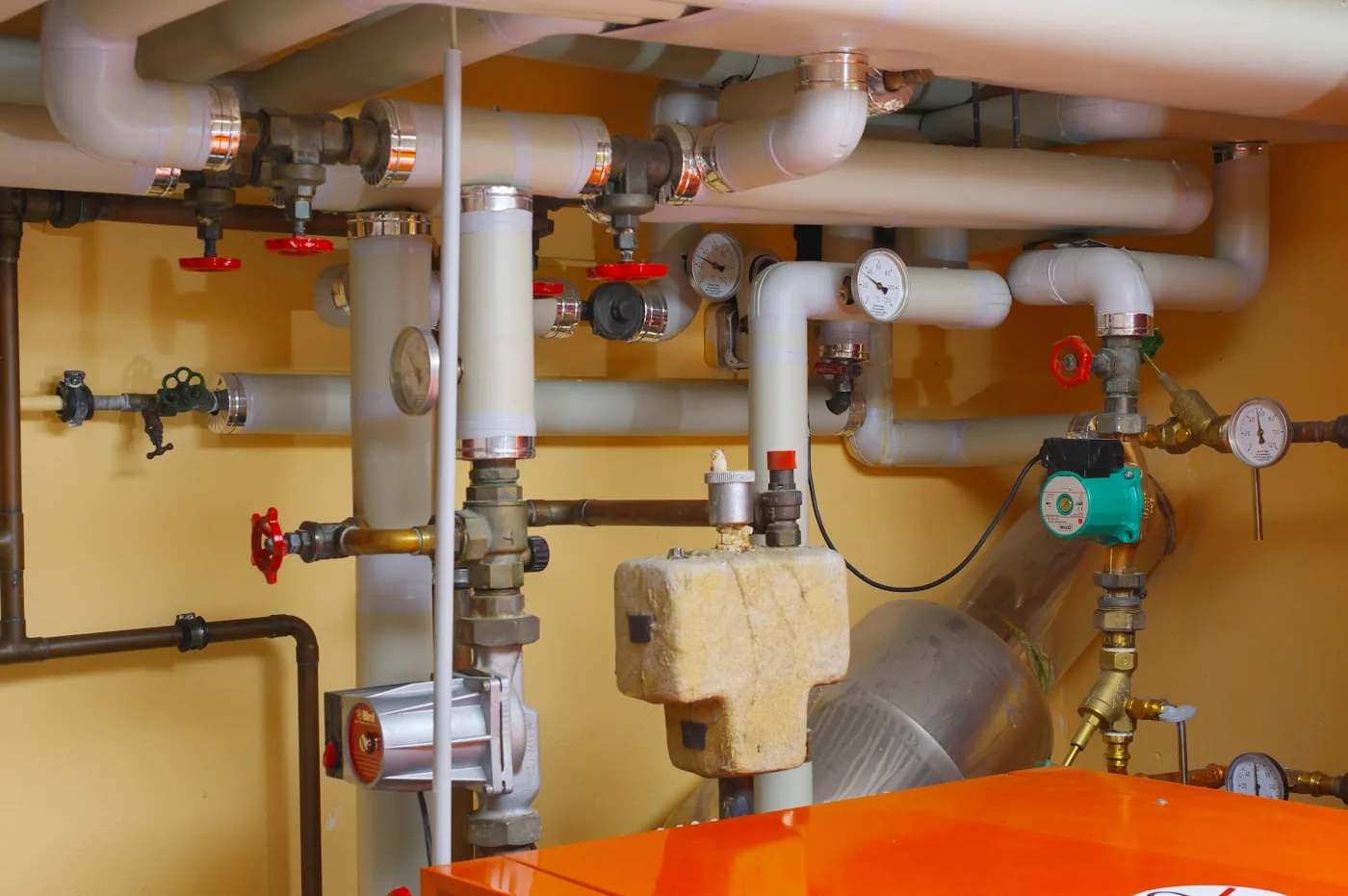 Heating plant room with boiler pipework and valves