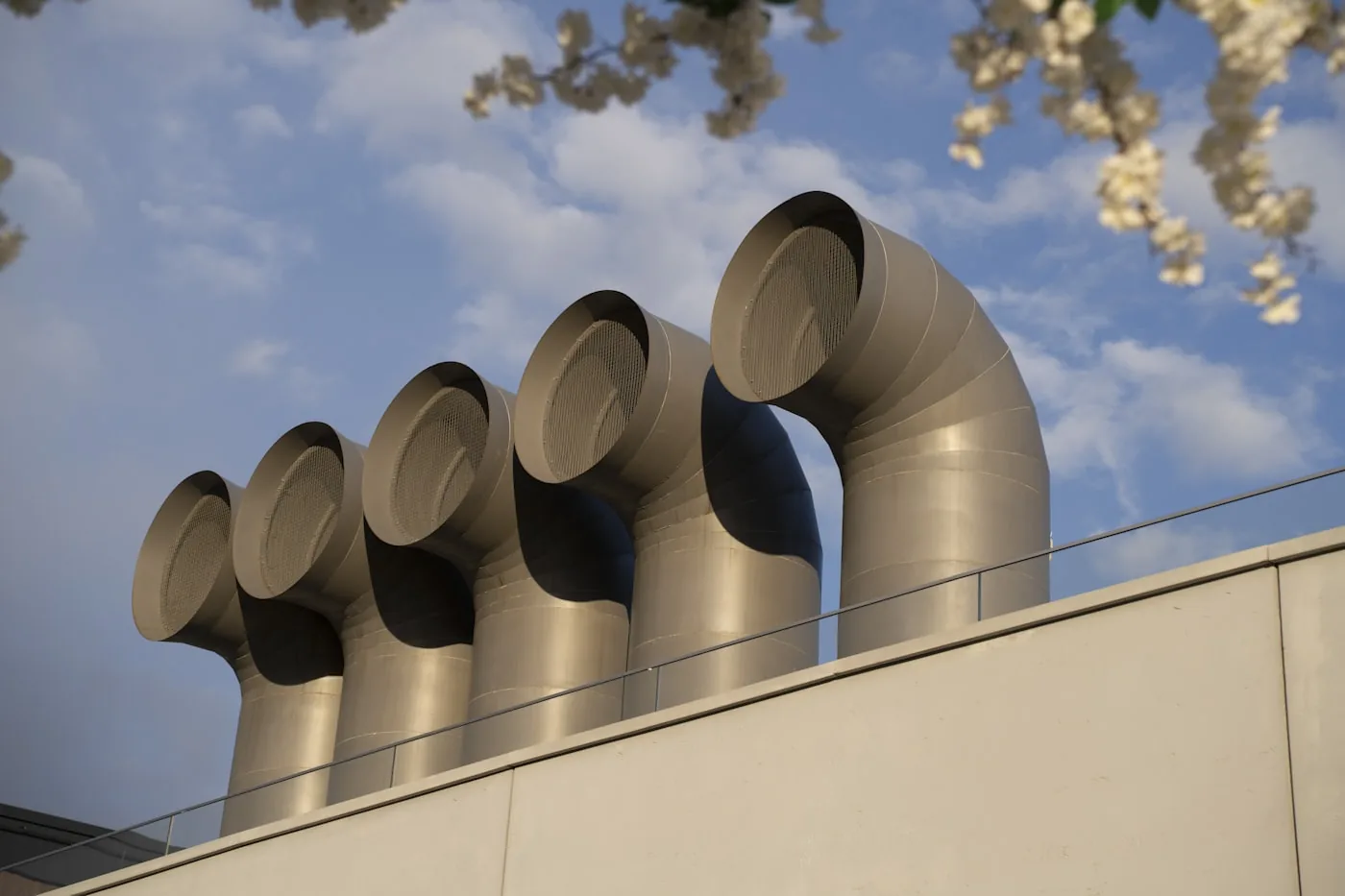 HVAC ventilation pipes and flues against an open sky