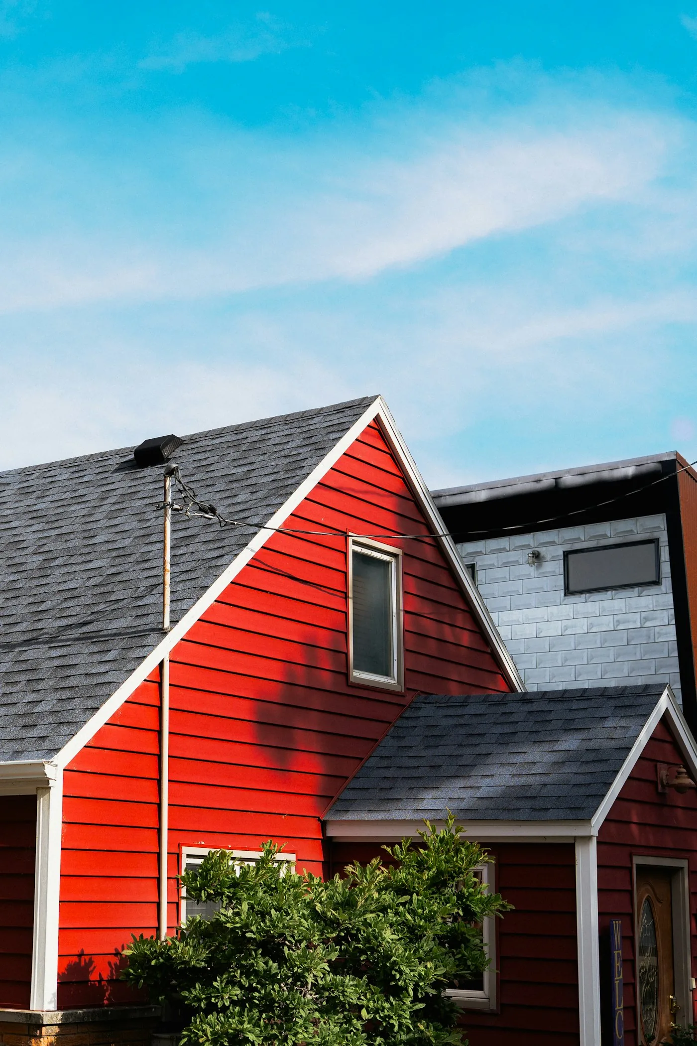 Residential roof against a clear blue sky