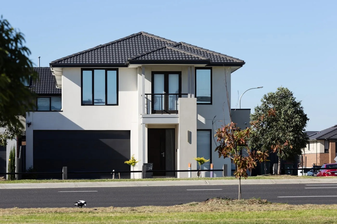 Two storey residential home with an attached garage and shingled roof