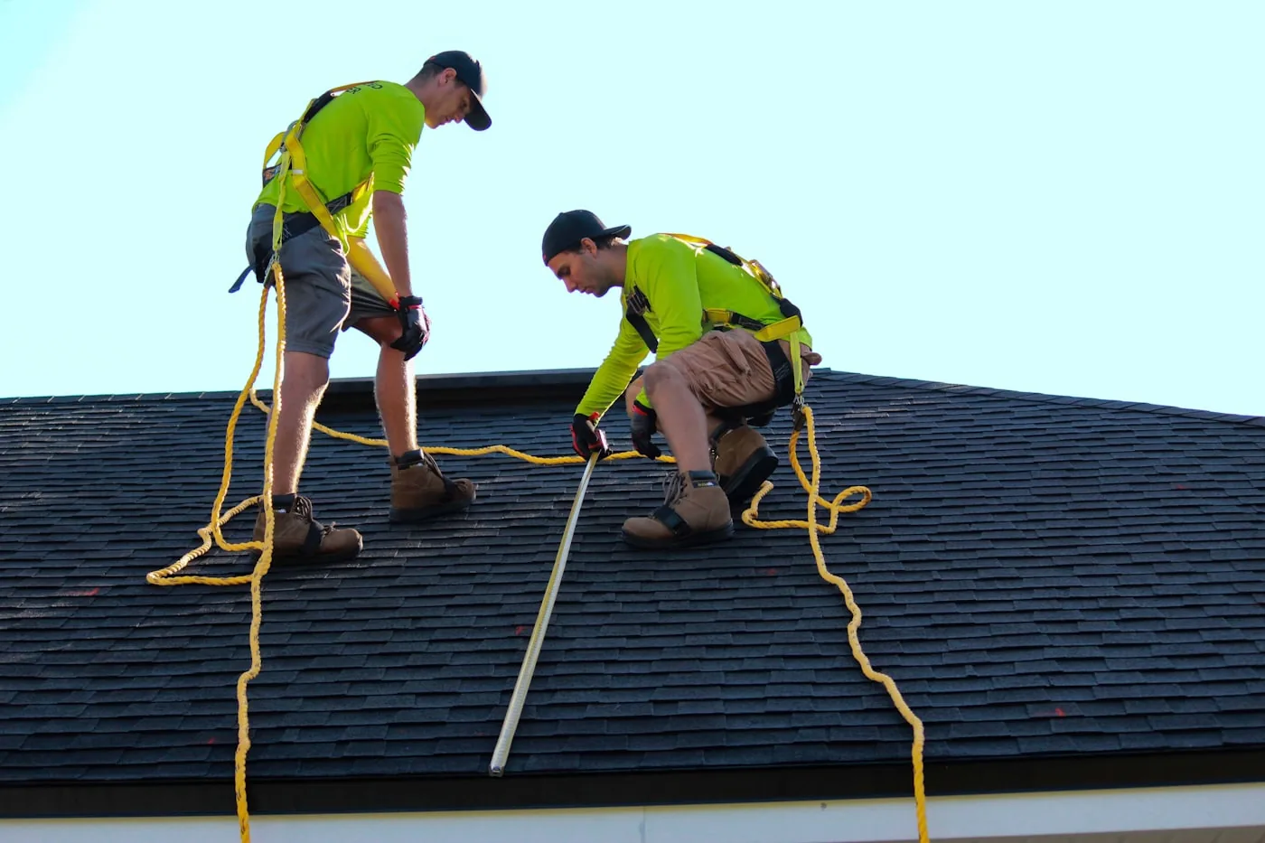 Roofing crew working together on a residential roof replacement