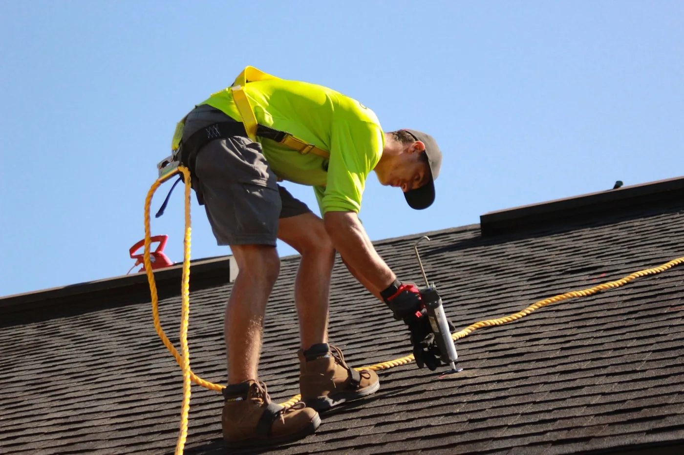 Roofer fastening roof decking with a power drill