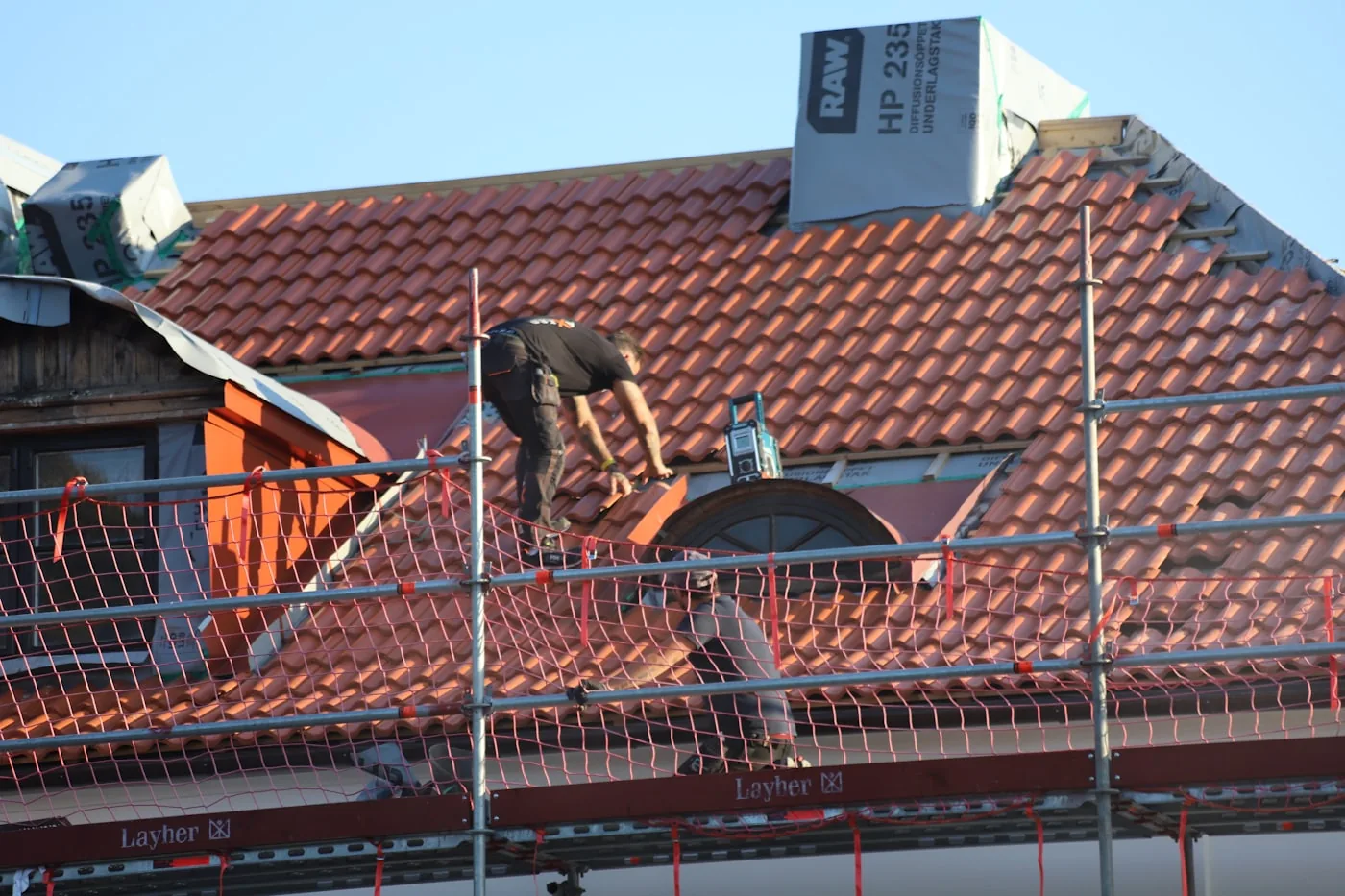 Roofing contractor working on a residential roof
