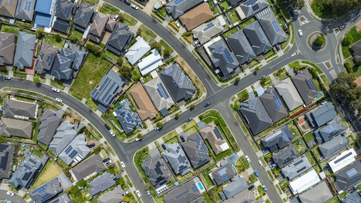 Aerial view of a suburban neighbourhood of shingled residential roofs