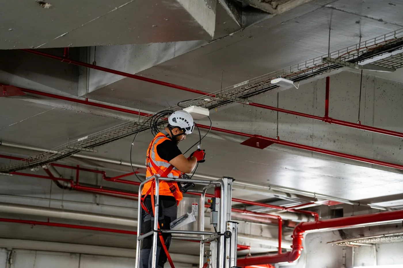 HVAC installer fitting ceiling ductwork components