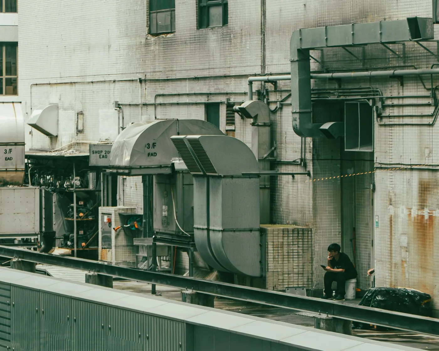 HVAC technician servicing outdoor mechanical equipment