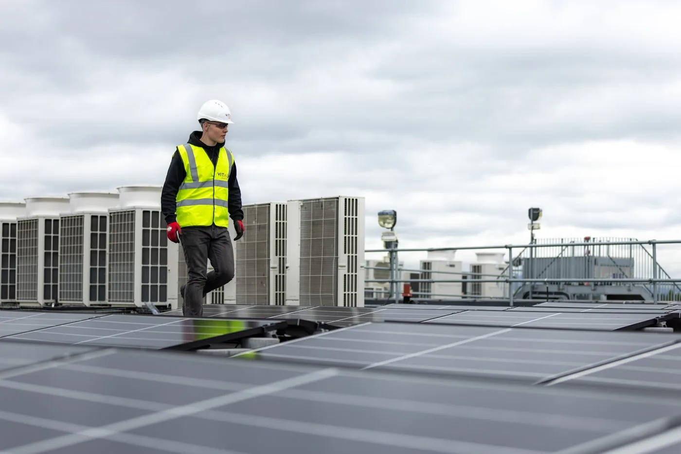 HVAC technician servicing rooftop equipment on a commercial building