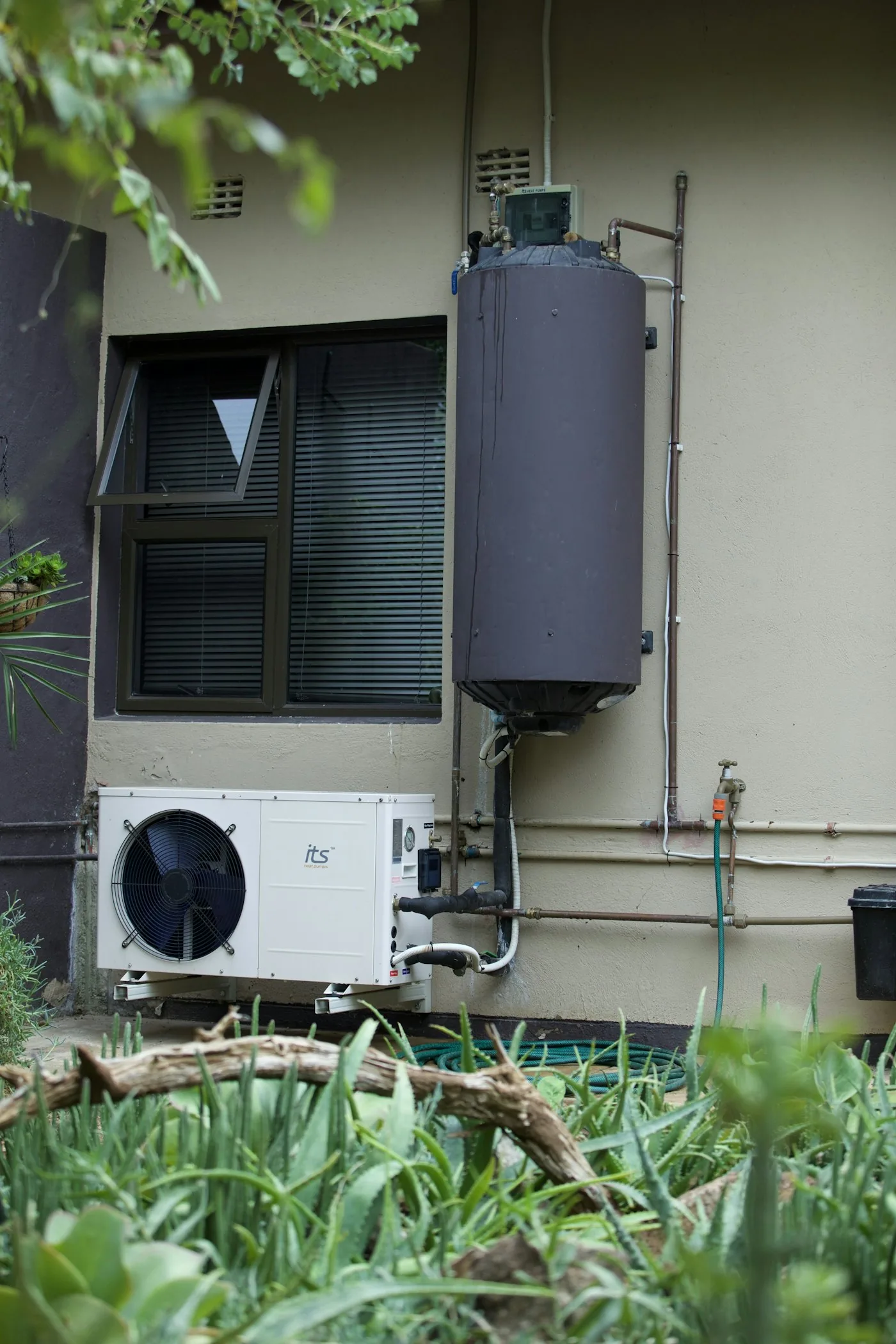 Residential water heater and air conditioning equipment on an exterior wall